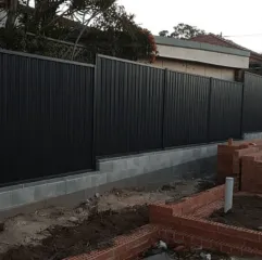 Dark aluminium fencing with brick pillars