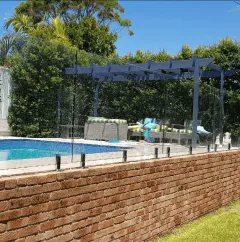 Glass pool fencing on a brick retaining wall
