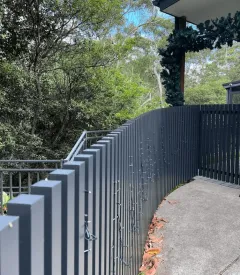 Black aluminium fencing on a sloped driveway