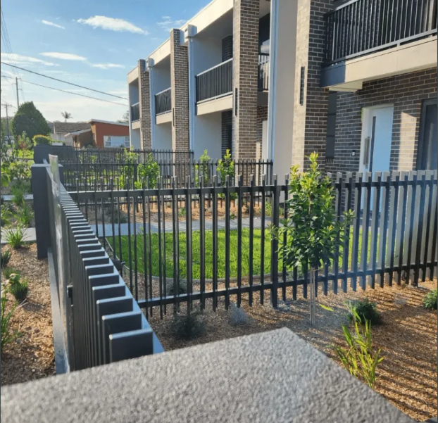Custom grey aluminium batten fencing around a landscaped front garden