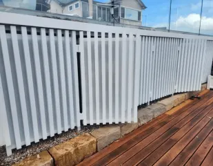 White aluminium slat fencing beside a deck