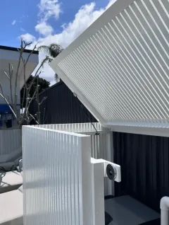 White aluminium slat fencing with dark feature backdrop