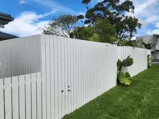 White aluminium boundary fencing and lawn