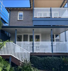 White aluminium balustrade and fencing on a brick home